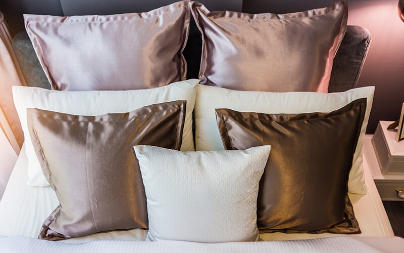 Mixed Silk Pillows on a bed